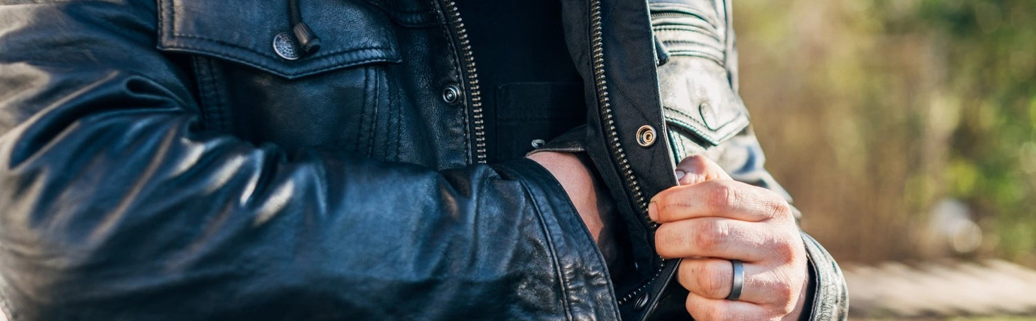 Man in Motorcycle Leather Biker Jacket Black Utility Jacket with Removable Mesh Liner Zipper Front Covered Snaps Double Chest Pockets