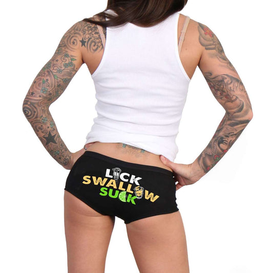 This image features a pair of women's boy shorts, designed with a bold and graphic print. The shorts are predominantly black with a striking phrase "LICK SWALLOW SUCK" printed in vibrant yellow and green across the back.