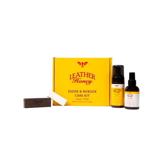 Leather Honey suede and nubuck care kit with a yellow box, bar of soap, and two bottles on a white background