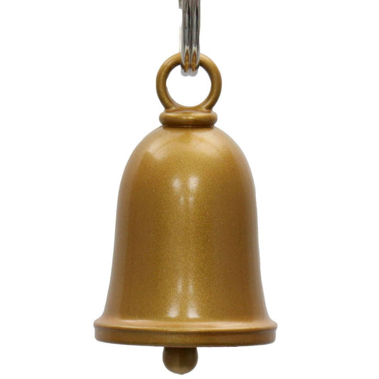 An antique gold colored metal motorcycle good luck bell with a key ring attached at the top.