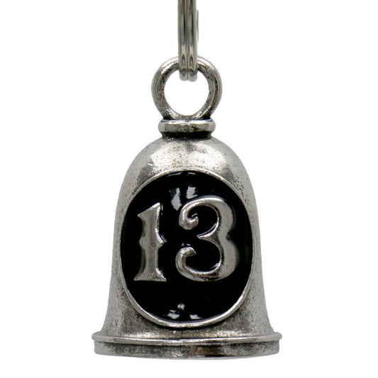 A silver-colored metal motorcycle bell with the number 13 on it, attached to a key ring.