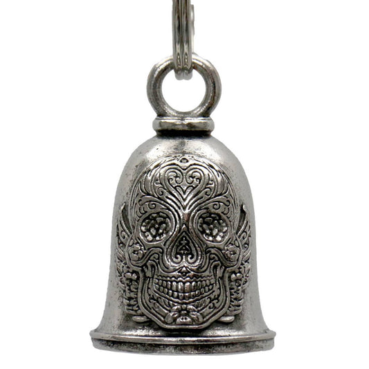 A silver motorcycle good luck bell with a sugar skull design and a key ring attached.