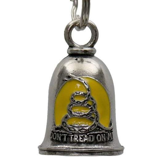 A silver-colored motorcycle good luck bell with a yellow face featuring a coiled snake emblem and the phrase 'DON'T TREAD ON ME', attached to a key ring.