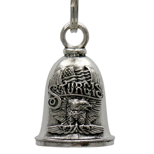 A silver-colored metal motorcycle good luck bell with an embossed design, including an eagle and the word 'STURGIS', attached to a key ring.