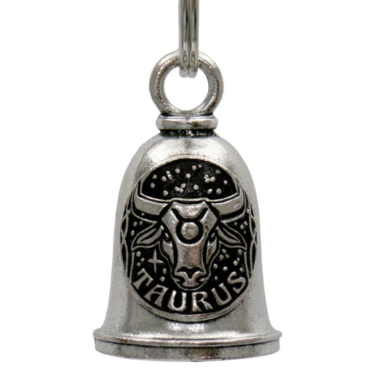 A silver-colored metal bell with the Taurus zodiac sign design, intended to be hung on a motorcycle as a decorative accessory with a key ring.