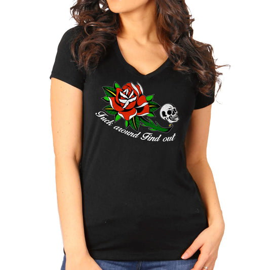 A woman wearing a black short-sleeved t-shirt with a graphic print of a rose and skull, and text on the front.