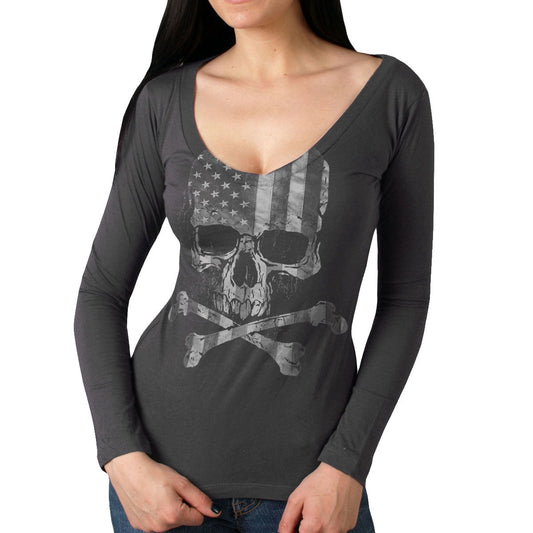 A woman wearing a long sleeve gray shirt with a skull and crossbones design resembling the American flag.