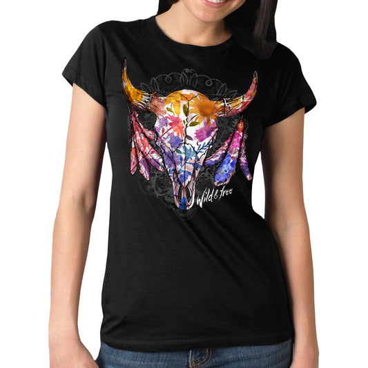 A woman wearing a short-sleeved black t-shirt with a colorful graphic print of a cattle skull, wildflowers, and the text 'WILD and FREE'.