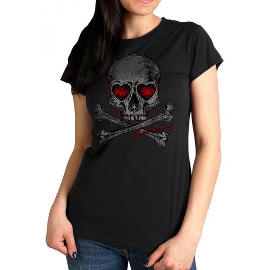 A woman wearing a black short-sleeved t-shirt with a graphic print of a skull with heart-shaped eyes and crossed bones.