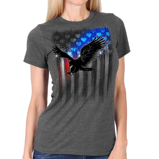 A woman wearing a heather gray short sleeve t-shirt with a graphic print of an eagle and abstract designs