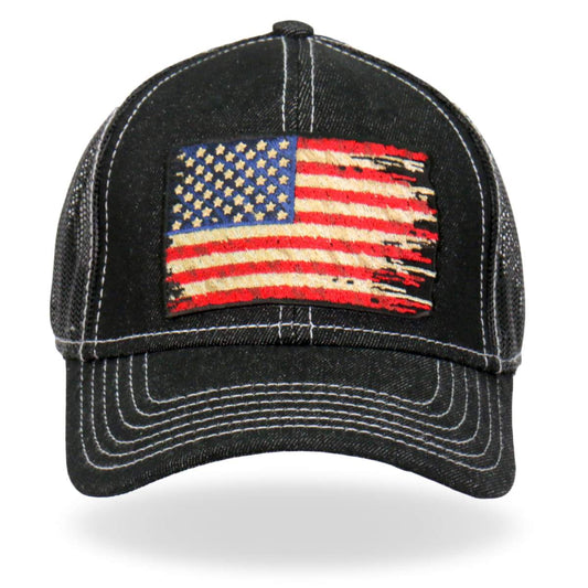 A black denim trucker hat with an embroidered American flag patch on the front panel, featuring a flat brim and snap closure.
