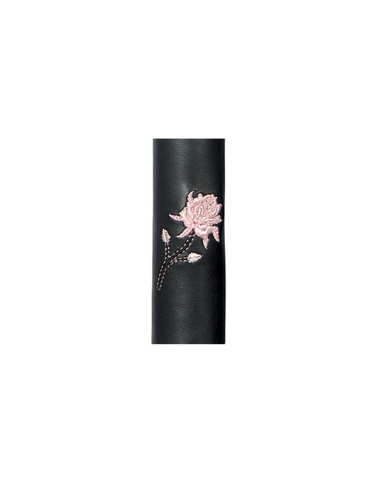 Black leather cylindrical hair tube product with a pink floral design on a white background