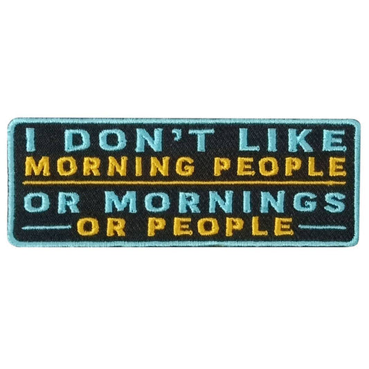 A rectangular embroidered patch with the text 'I DON'T LIKE MORNING PEOPLE OR MORNINGS OR PEOPLE' in capital letters, with a blue background and yellow and black text.