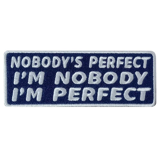 A rectangular blue and white embroidered patch with the text 'NOBODY'S PERFECT I'M NOBODY I'M PERFECT'.