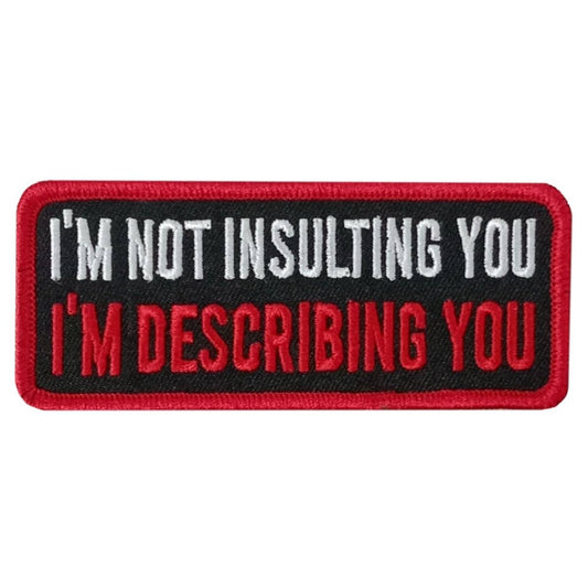 A red, black, and white embroidered patch with the text 'I'M NOT INSULTING YOU I'M DESCRIPTION YOU'.