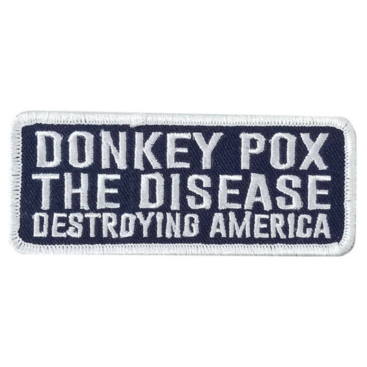 A rectangular fabric patch with a blue border and white text that reads 'DONKEY POX THE DISEASE DESTROYING AMERICA'.