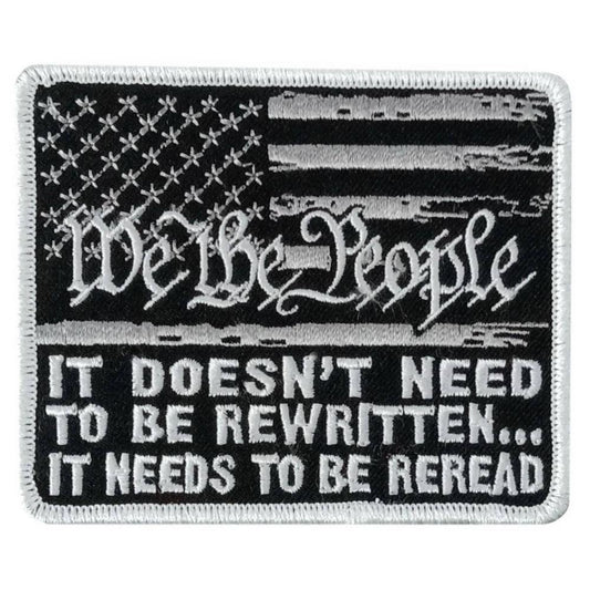 A rectangular black and white embroidered patch with the text 'We The People' and a stylized American flag design. The patch measures 3.