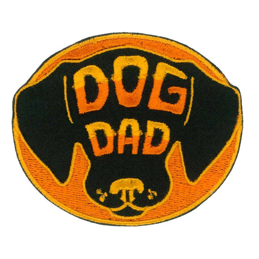 An embroidered patch with the text 'DOG DAD' and a silhouette of a dog's head, primarily in black and orange colors.