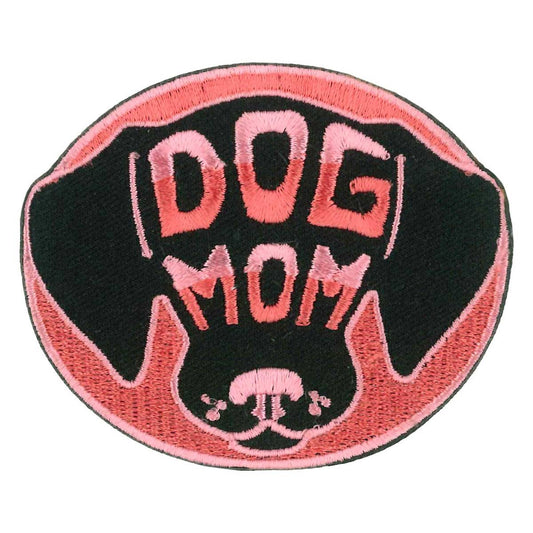 A patch with a black and pink design featuring the text 'DOG MOM' and a stylized representation of a dog's face.