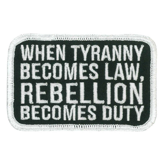 A black and white embroidered patch with the text 'WHEN TYRANNY BECOMES LAW, REBELLION BECOMES DUTY'.